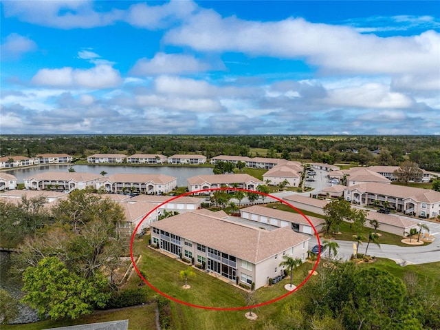 drone / aerial view featuring a residential view and a water view