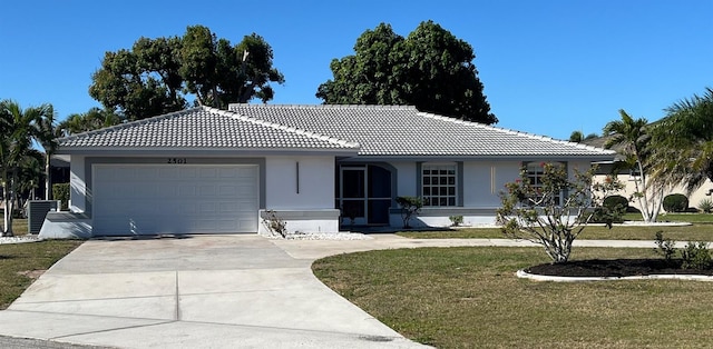 single story home with a front lawn, a tiled roof, concrete driveway, stucco siding, and an attached garage