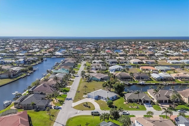 drone / aerial view featuring a residential view and a water view