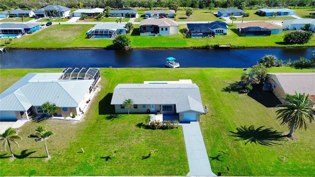 drone / aerial view with a water view and a residential view