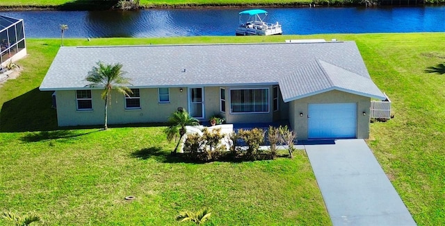 ranch-style house with a front yard, a water view, and driveway