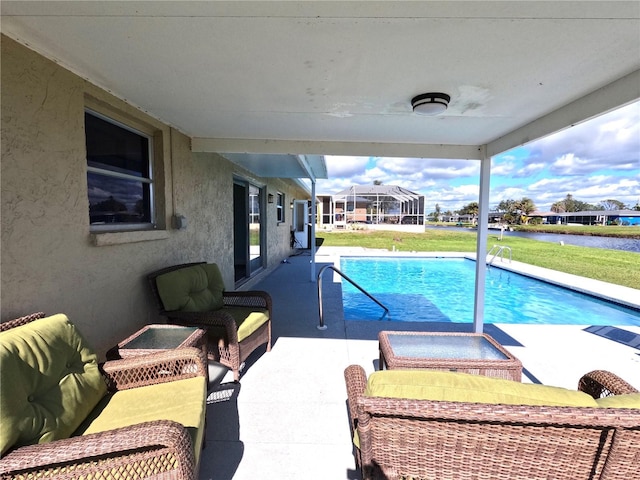 pool featuring a water view, a patio area, glass enclosure, and a yard