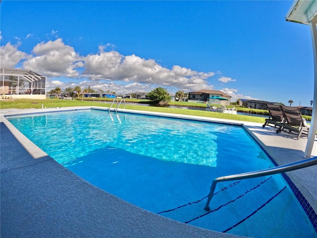 outdoor pool featuring a yard and a patio