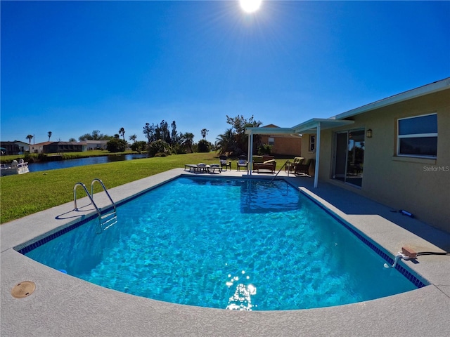 pool featuring a patio, a lawn, and a water view