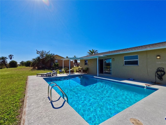 pool featuring a yard and a patio area