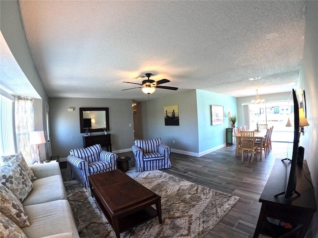 living room featuring visible vents, baseboards, a textured ceiling, wood finish floors, and ceiling fan with notable chandelier