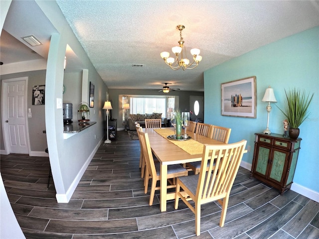 dining room with wood tiled floor, visible vents, and baseboards