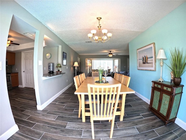 dining space with visible vents, wood tiled floor, a textured ceiling, baseboards, and ceiling fan with notable chandelier