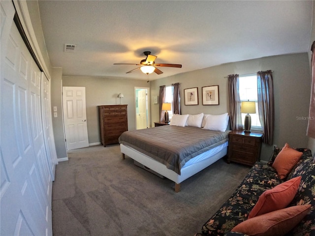 bedroom featuring baseboards, visible vents, a ceiling fan, carpet floors, and a closet