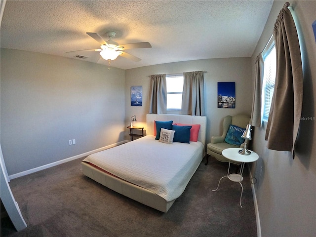 bedroom featuring carpet, visible vents, a ceiling fan, a textured ceiling, and baseboards