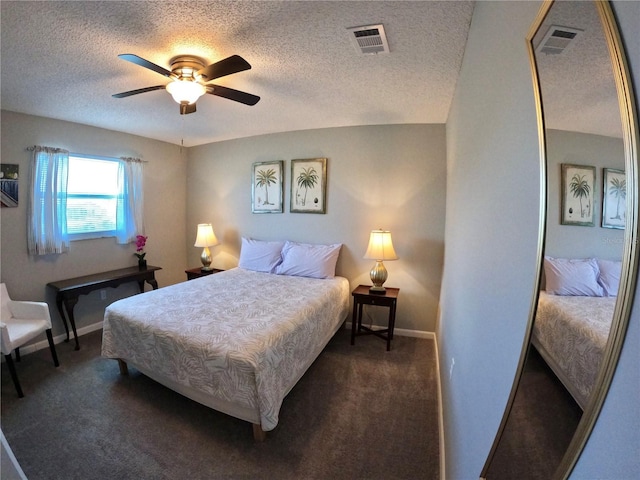 bedroom with visible vents, dark carpet, ceiling fan, and baseboards