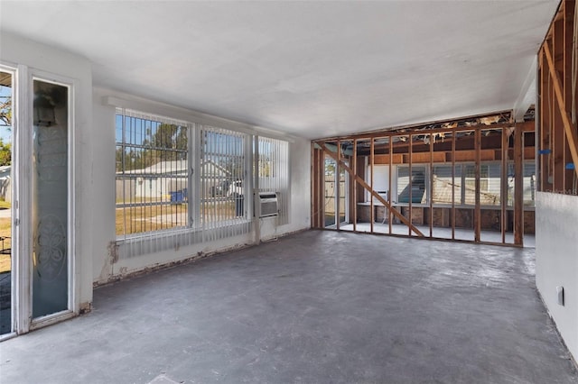 interior space featuring unfinished concrete flooring and cooling unit