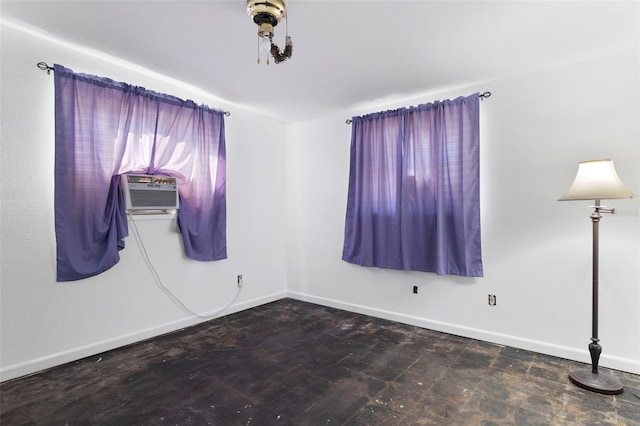 empty room featuring cooling unit and baseboards