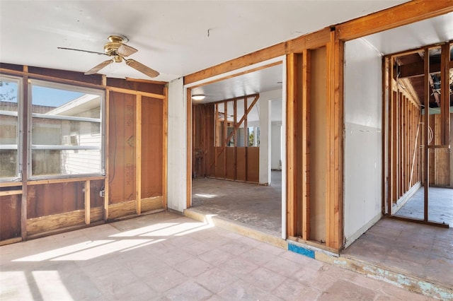 interior space with ceiling fan and tile patterned floors