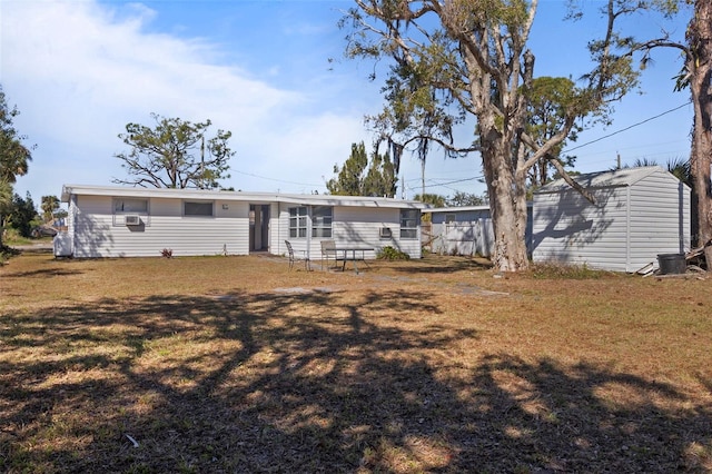 back of house featuring an outdoor structure and a yard