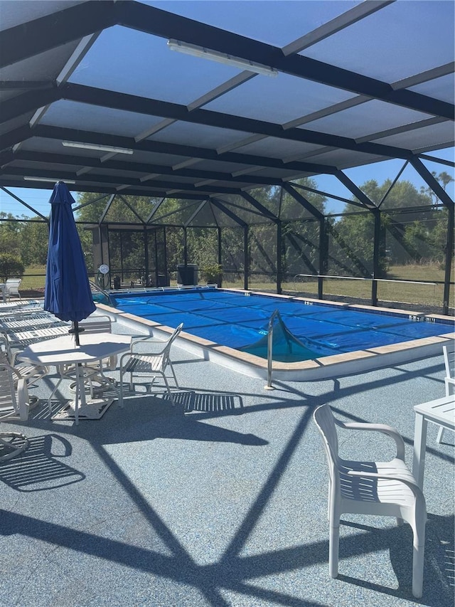 view of swimming pool featuring a patio, a lanai, and a covered pool