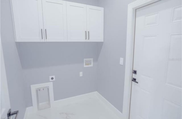 laundry area with hookup for a washing machine, hookup for an electric dryer, baseboards, marble finish floor, and cabinet space