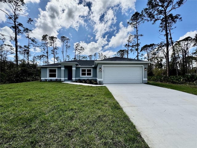 view of front facade with driveway, a front lawn, an attached garage, and stucco siding