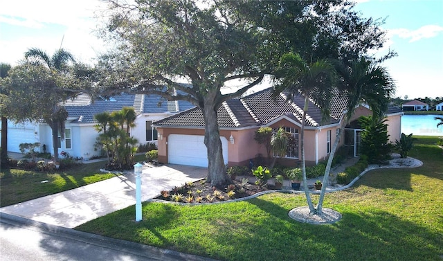 view of front facade featuring a garage, a front yard, a tile roof, and driveway