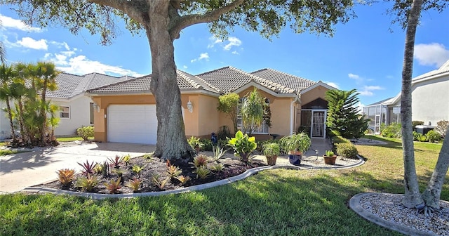 view of front of property featuring a front yard, concrete driveway, a tile roof, and stucco siding