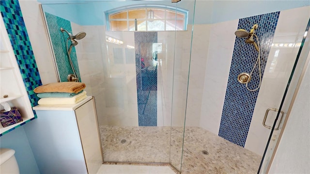 bathroom featuring a tile shower and toilet