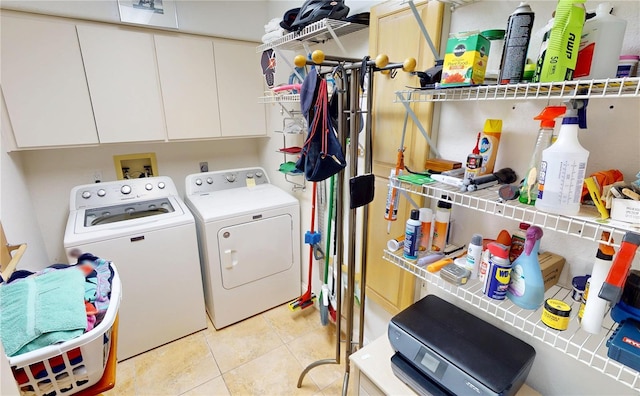 laundry room with light tile patterned floors and washing machine and dryer