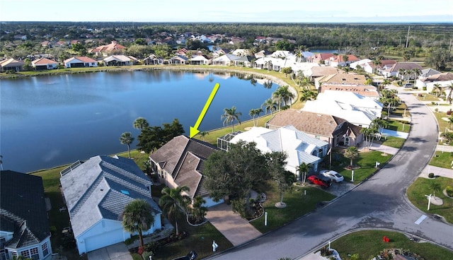 drone / aerial view featuring a residential view and a water view