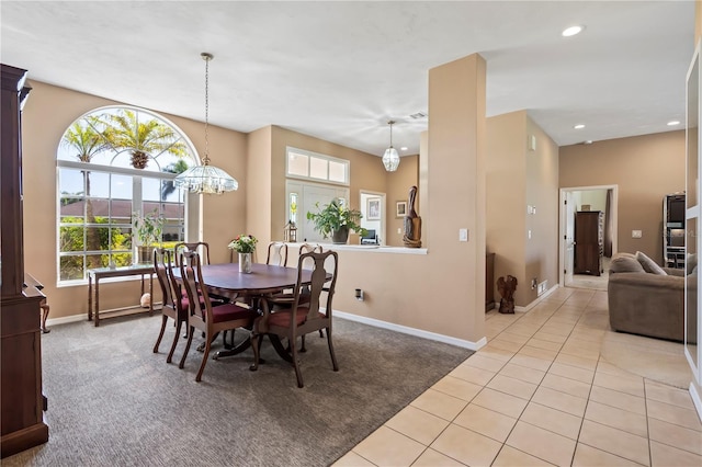 dining area with recessed lighting, light colored carpet, baseboards, and light tile patterned floors