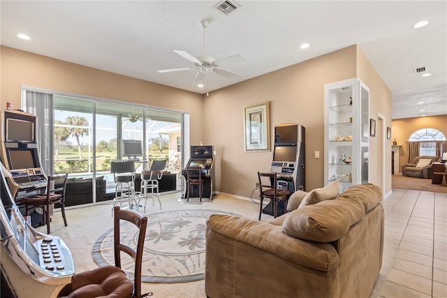 living area with a wealth of natural light, visible vents, ceiling fan, and recessed lighting