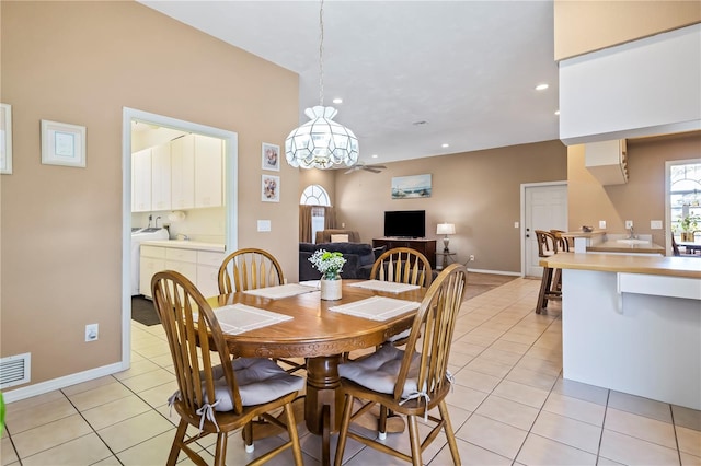 dining space featuring light tile patterned floors, washing machine and dryer, visible vents, and recessed lighting