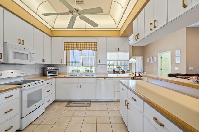 kitchen with light tile patterned flooring, white appliances, a sink, a ceiling fan, and white cabinets