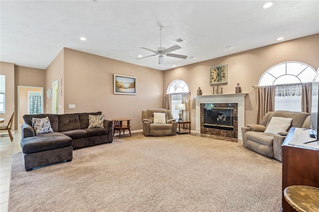 carpeted living area with baseboards, a fireplace, visible vents, and recessed lighting