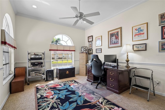 carpeted office with ceiling fan, baseboards, and crown molding