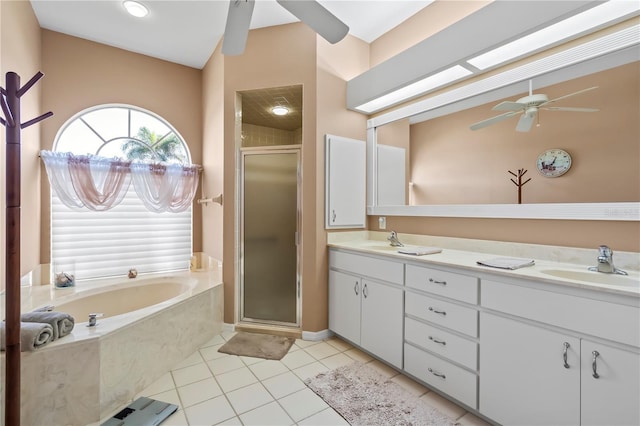 full bath with ceiling fan, tile patterned floors, a sink, a shower stall, and a bath