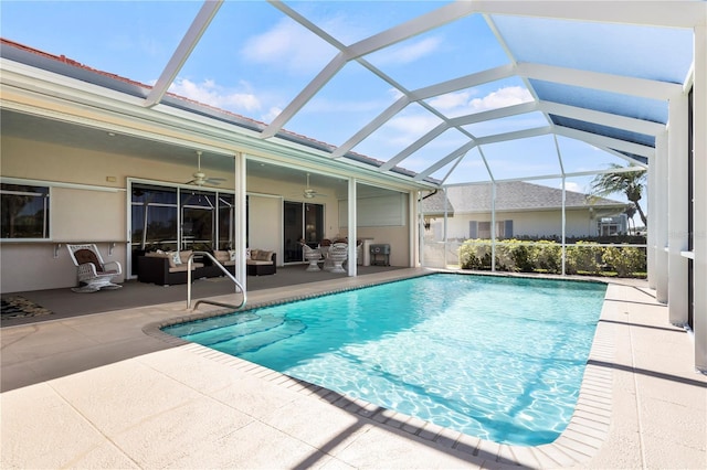 pool with glass enclosure, a patio, an outdoor living space, and ceiling fan