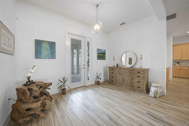 42239 Lake Timber Dr, Punta Gorda, FL 33982 - entryway with light wood-type flooring, visible vents, and baseboards