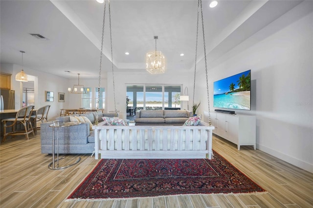 42239 Lake Timber Dr, Punta Gorda, FL 33982 - living room with light wood-type flooring, a raised ceiling, visible vents, and recessed lighting