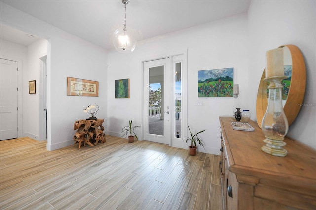 42239 Lake Timber Dr, Punta Gorda, FL 33982 - foyer entrance with light wood-style flooring and baseboards