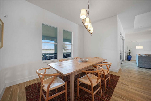42239 Lake Timber Dr, Punta Gorda, FL 33982 - dining space featuring light wood-style floors and baseboards
