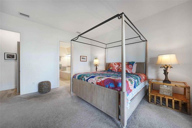 42239 Lake Timber Dr, Punta Gorda, FL 33982 - carpeted bedroom featuring visible vents and ensuite bathroom