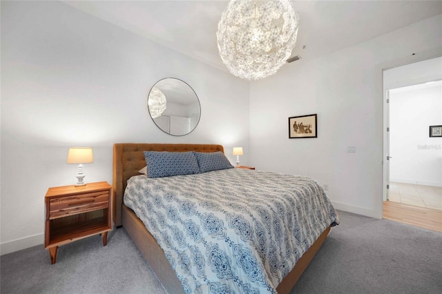 42239 Lake Timber Dr, Punta Gorda, FL 33982 - bedroom featuring a notable chandelier, carpet flooring, visible vents, and baseboards