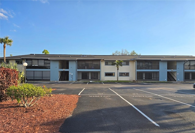 view of property featuring uncovered parking