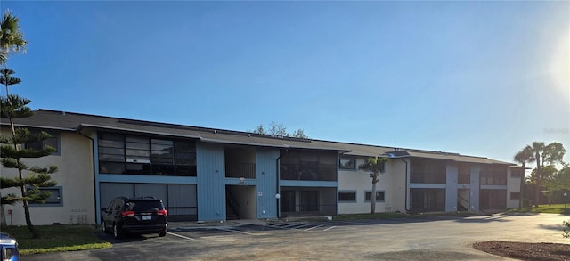 view of building exterior with uncovered parking