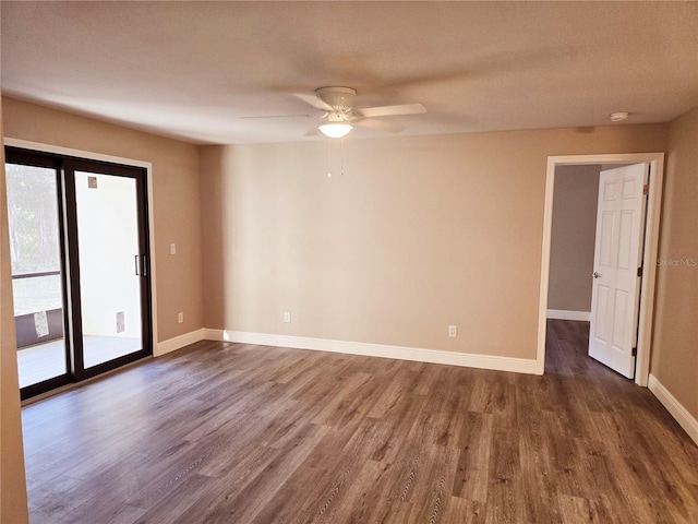 unfurnished room with ceiling fan, baseboards, and dark wood-style flooring