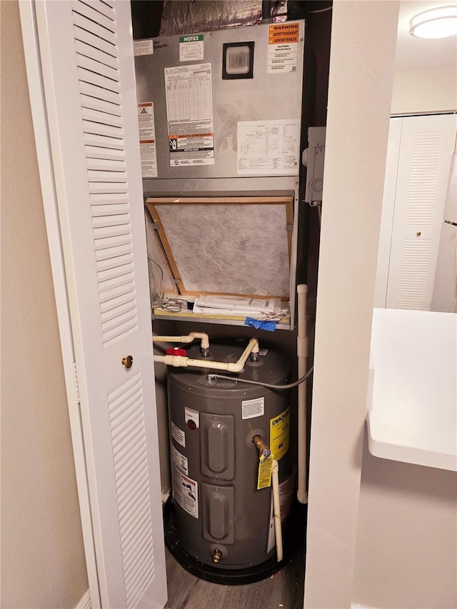 utility room with electric water heater