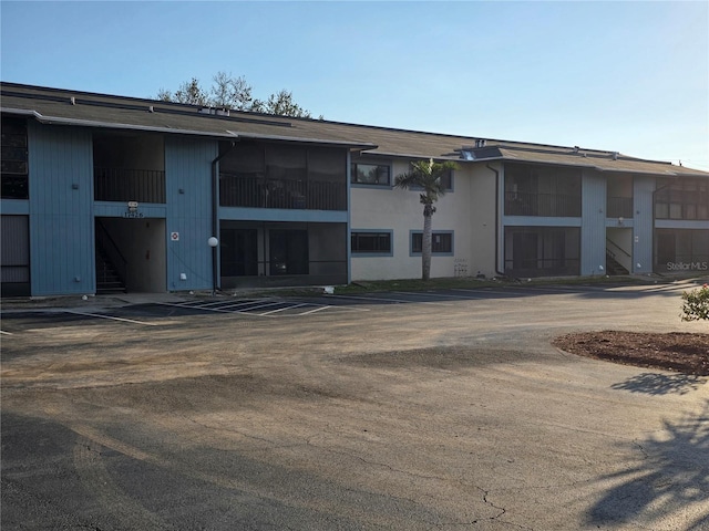 view of building exterior with uncovered parking