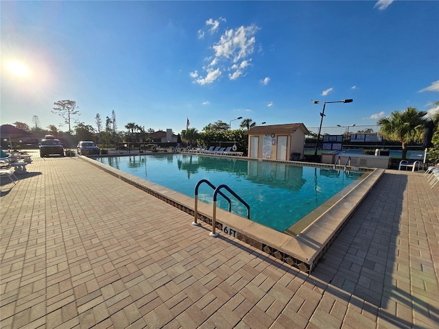 community pool with a patio area