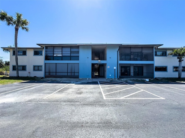 view of property featuring uncovered parking