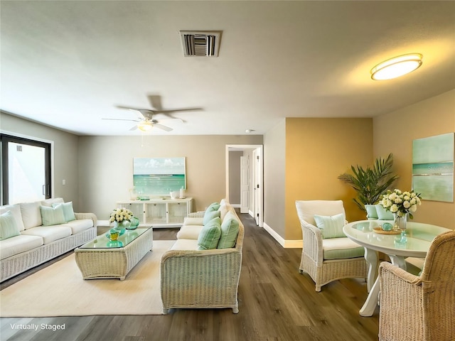 living area featuring baseboards, ceiling fan, wood finished floors, and visible vents