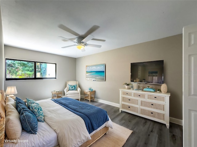 bedroom featuring baseboards, a ceiling fan, and dark wood-type flooring